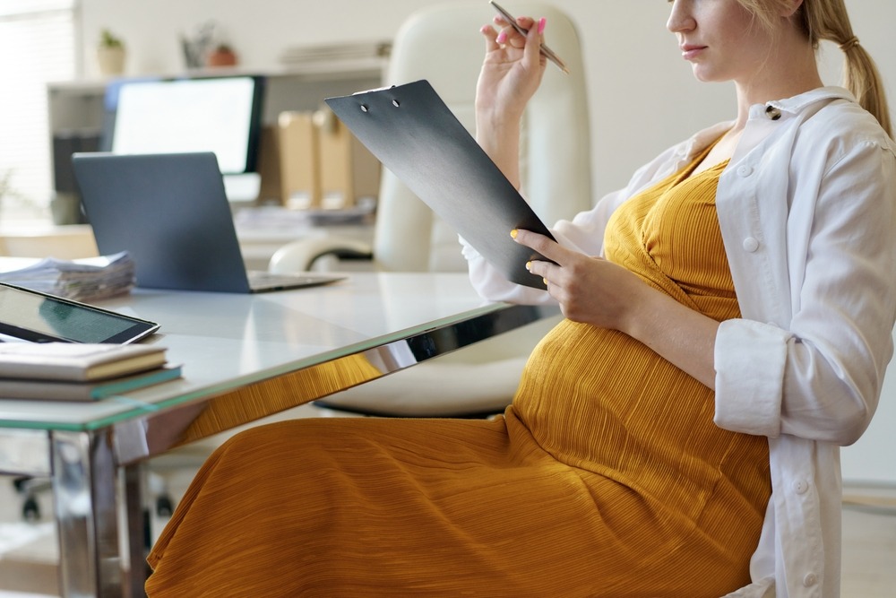 A woman filling out insurance documents